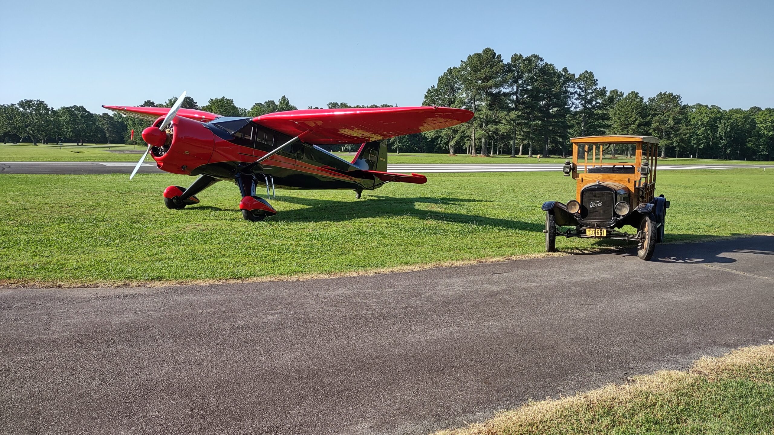 Restored Stinson high-wing taildragger and Ford Model T Wood paneled Auto