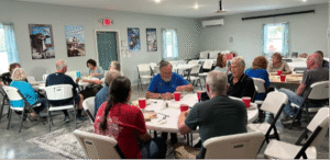 Enjoying a pot luck dinner with friends at the community center