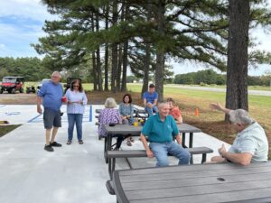 People visiting around picnic tables